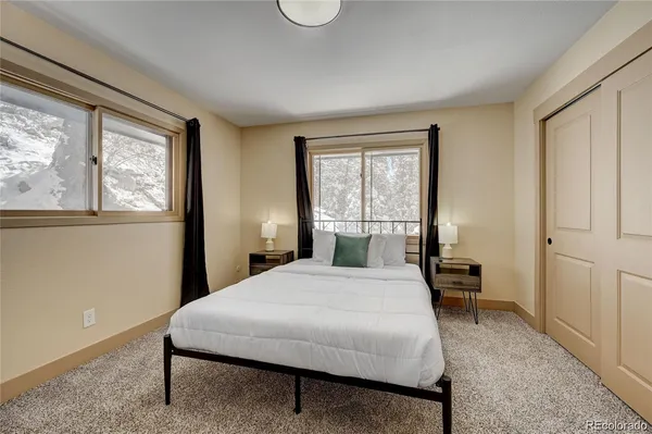 a bedroom with a large bed and a window