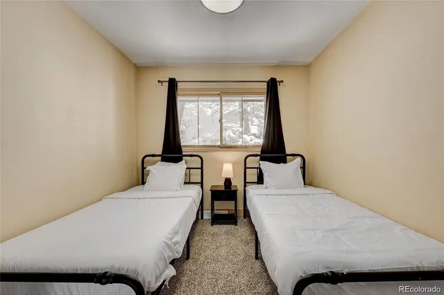 a bedroom with two beds and a window