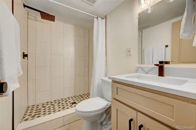 a bathroom with a sink toilet and shower