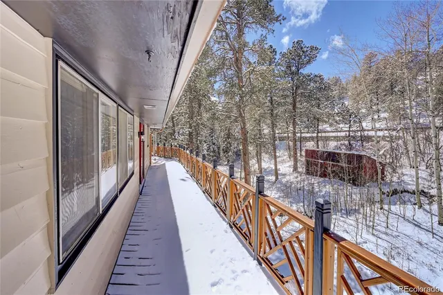 a view of a balcony with wooden floor and stairs