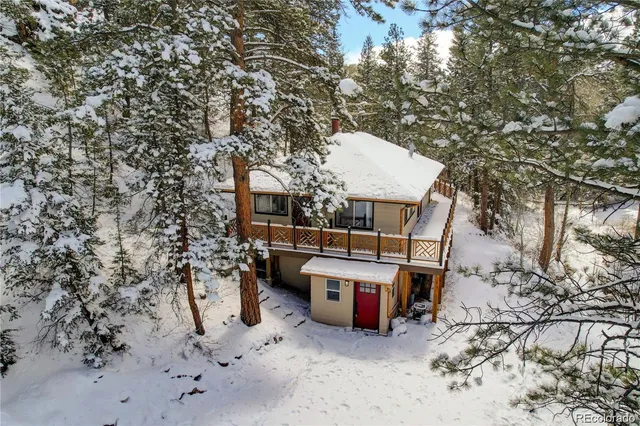 a view of a terrace with chairs and wooden fence