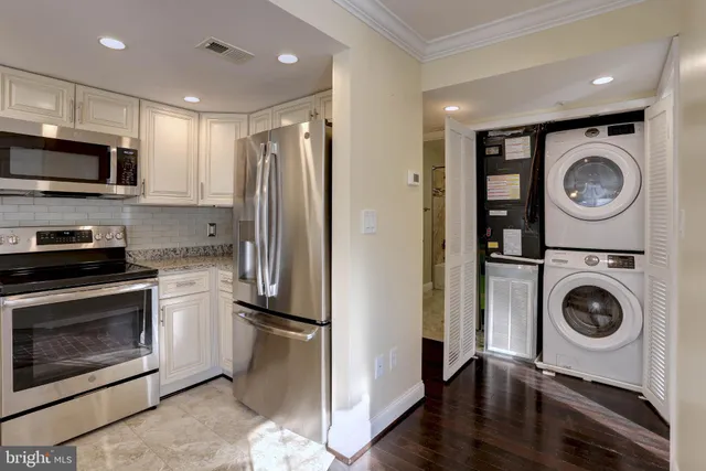 a kitchen with a refrigerator a washer and dryer