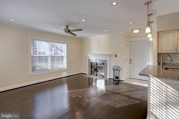 a living room with fireplace furniture and a wooden floor