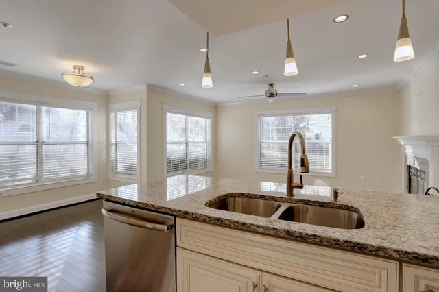 a kitchen with a sink and a large window