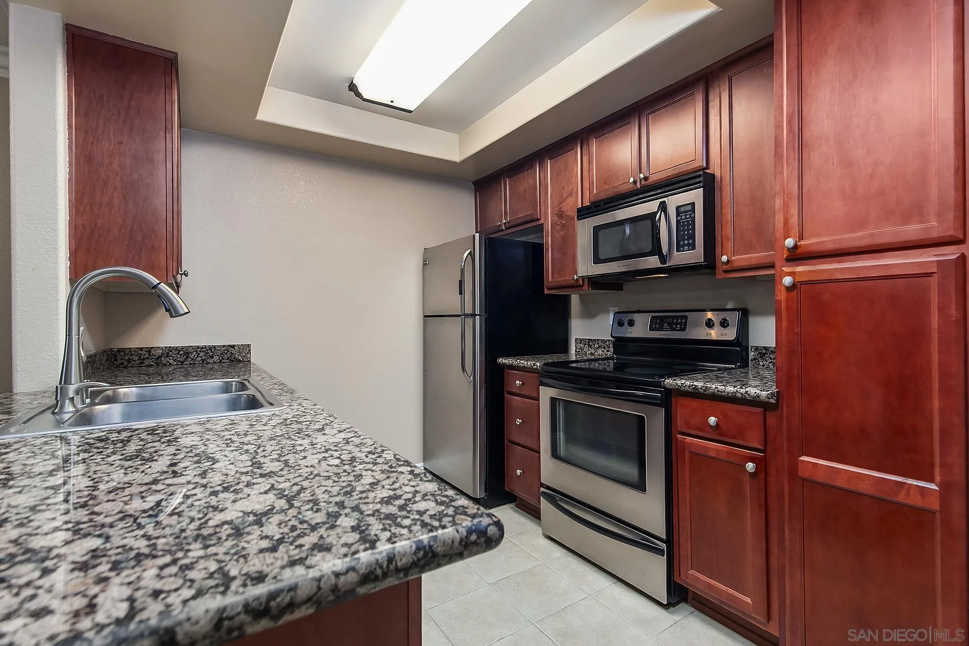 1434 Marshall Road, Unit 56 Alpine, CA 91901 - Photo 1 of 14 a kitchen with stainless steel appliances granite countertop a stove a microwave and a sink