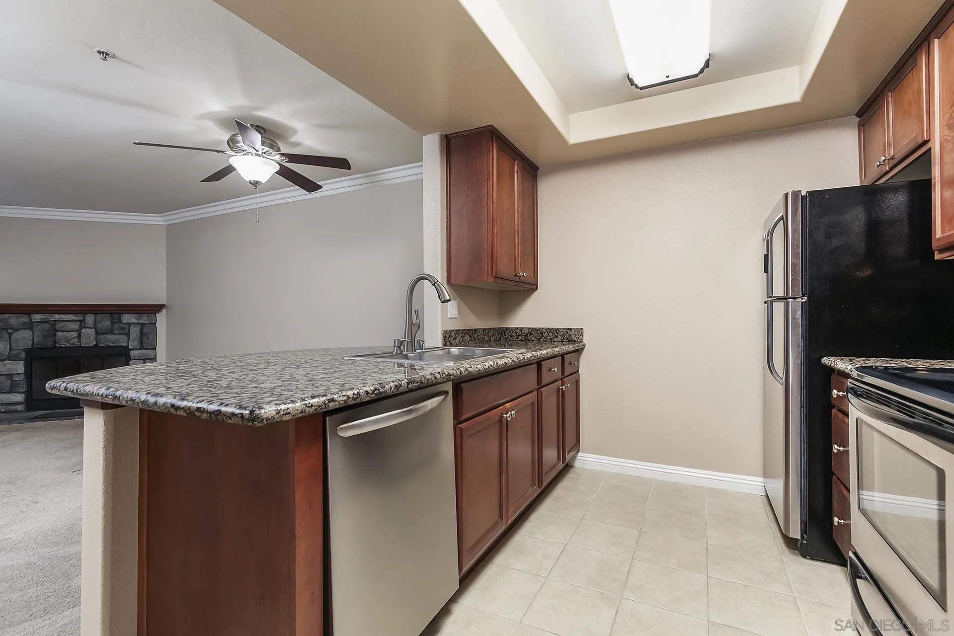 1434 Marshall Road, Unit 56 Alpine, CA 91901 - Photo 2 of 14 a kitchen with stainless steel appliances granite countertop a stove a refrigerator and a sink