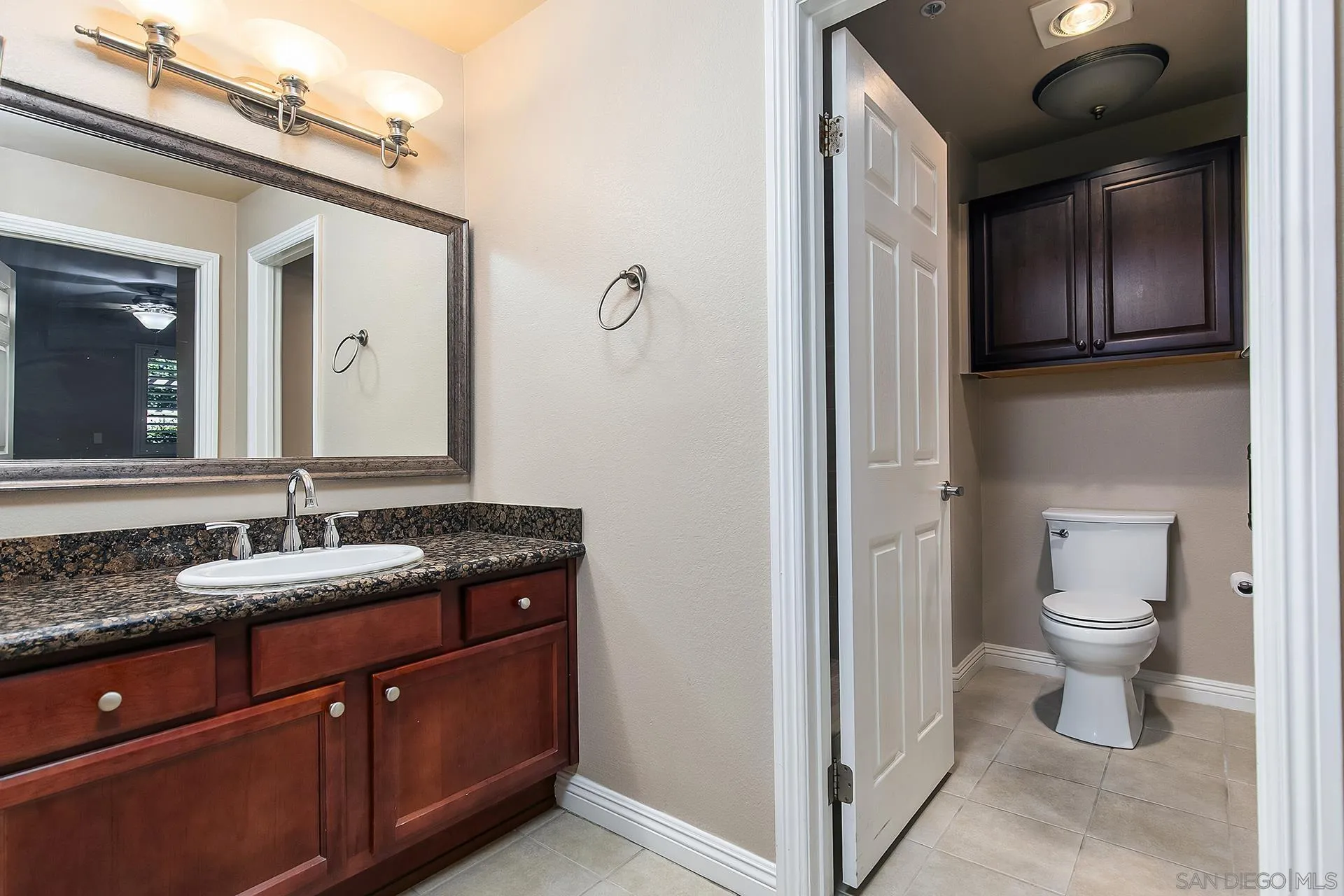 1434 Marshall Road, Unit 56 Alpine, CA 91901 - Photo 7 of 14 a spacious bathroom with a granite countertop toilet sink and mirror