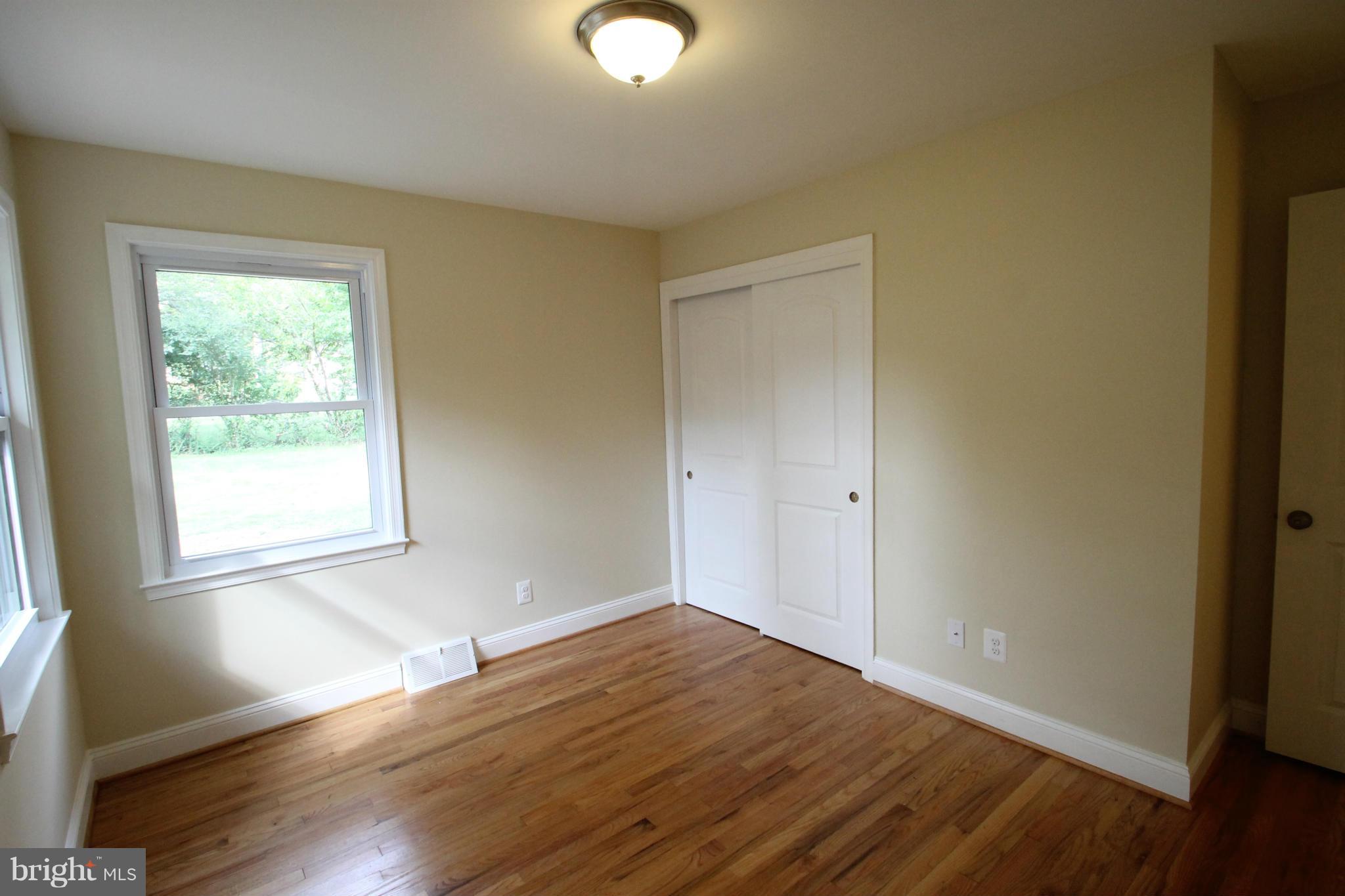 1520 Daytona Road Baltimore, MD 21234 - Photo 17 of 24 a view of an empty room with wooden floor and a window