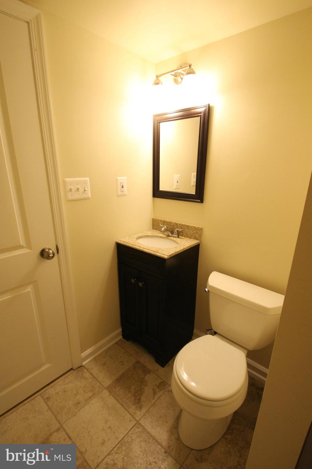 1520 Daytona Road Baltimore, MD 21234 - Photo 24 of 24 a bathroom with a toilet a sink and mirror