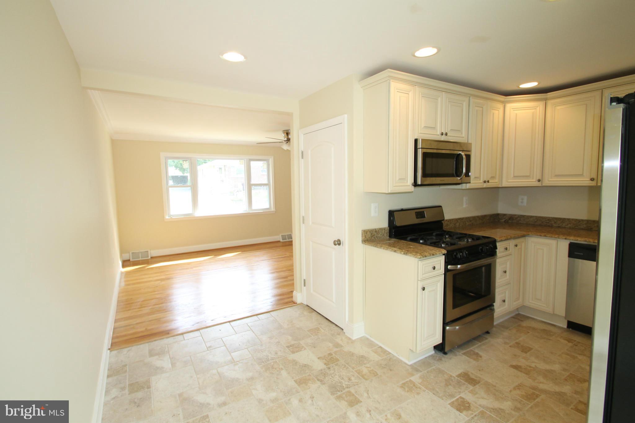 1520 Daytona Road Baltimore, MD 21234 - Photo 8 of 24 a kitchen with a stove a sink and a microwave