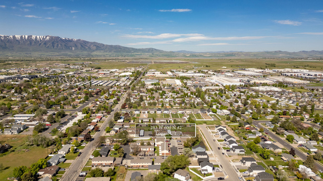 283 West 600 North, Unit 2 Logan, UT 84321 - Photo 26 of 36 Aerial perspective showcasing a residential neighborhood with a mountainous backdrop