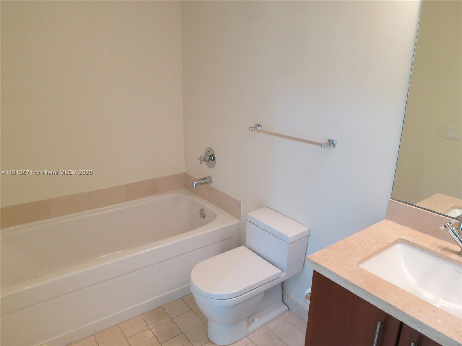 1111 Southwest 1st Avenue, Unit 1024N Miami, FL 33130 - Photo 7 of 12 a bathroom with a sink a toilet and bathtub