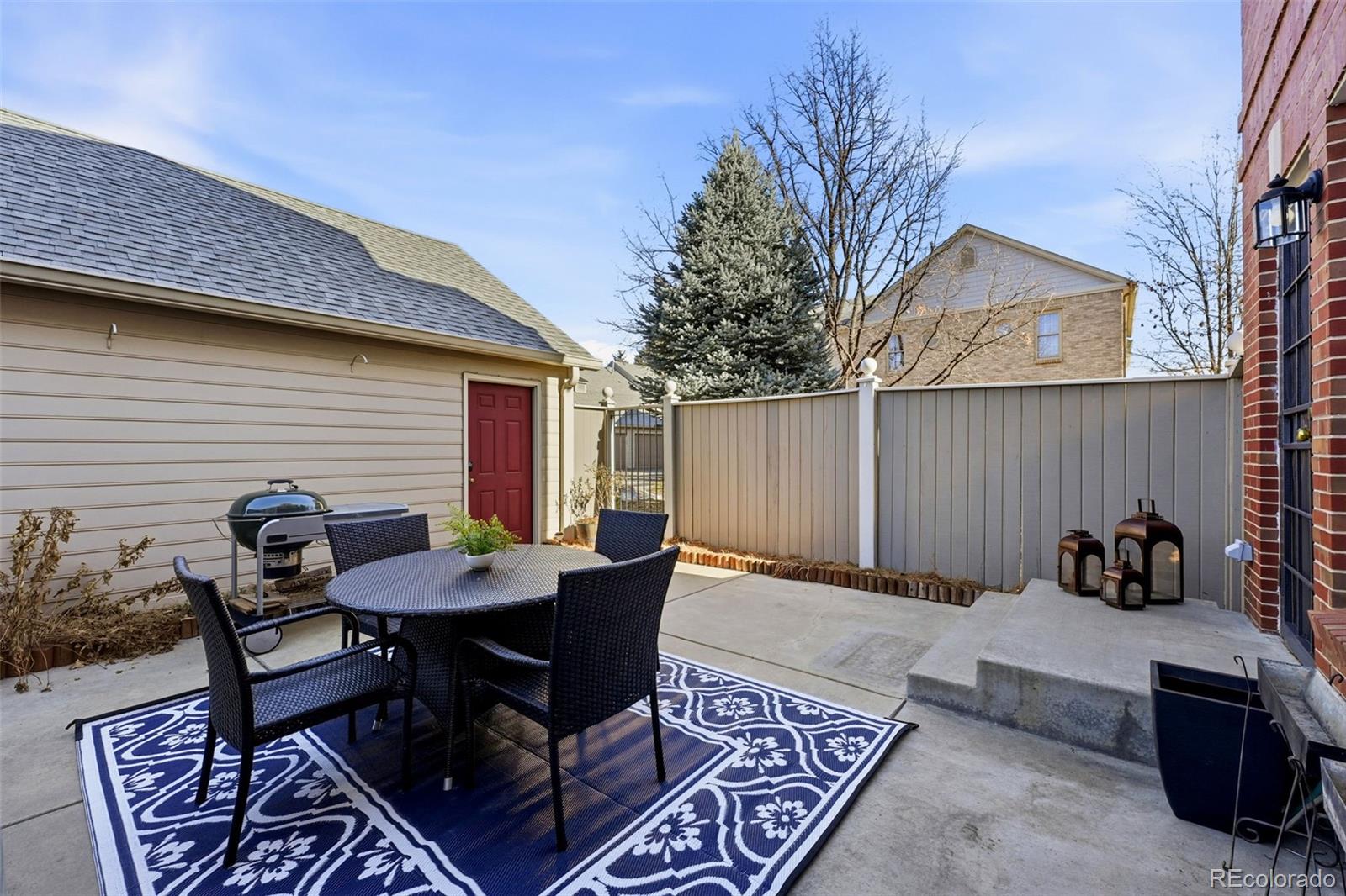 944 Ivanhoe Street Denver, CO 80220 - Photo 35 of 50 a backyard of a house with dining table and chairs