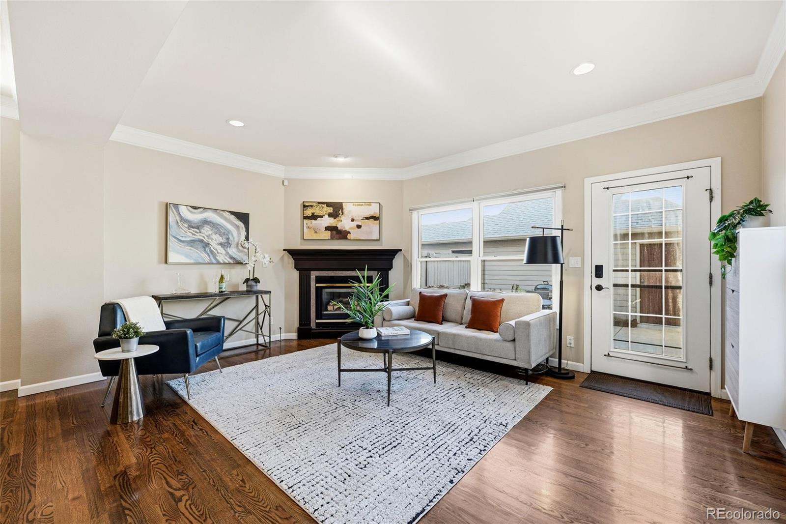 944 Ivanhoe Street Denver, CO 80220 - Photo 6 of 50 a living room with furniture and a fireplace