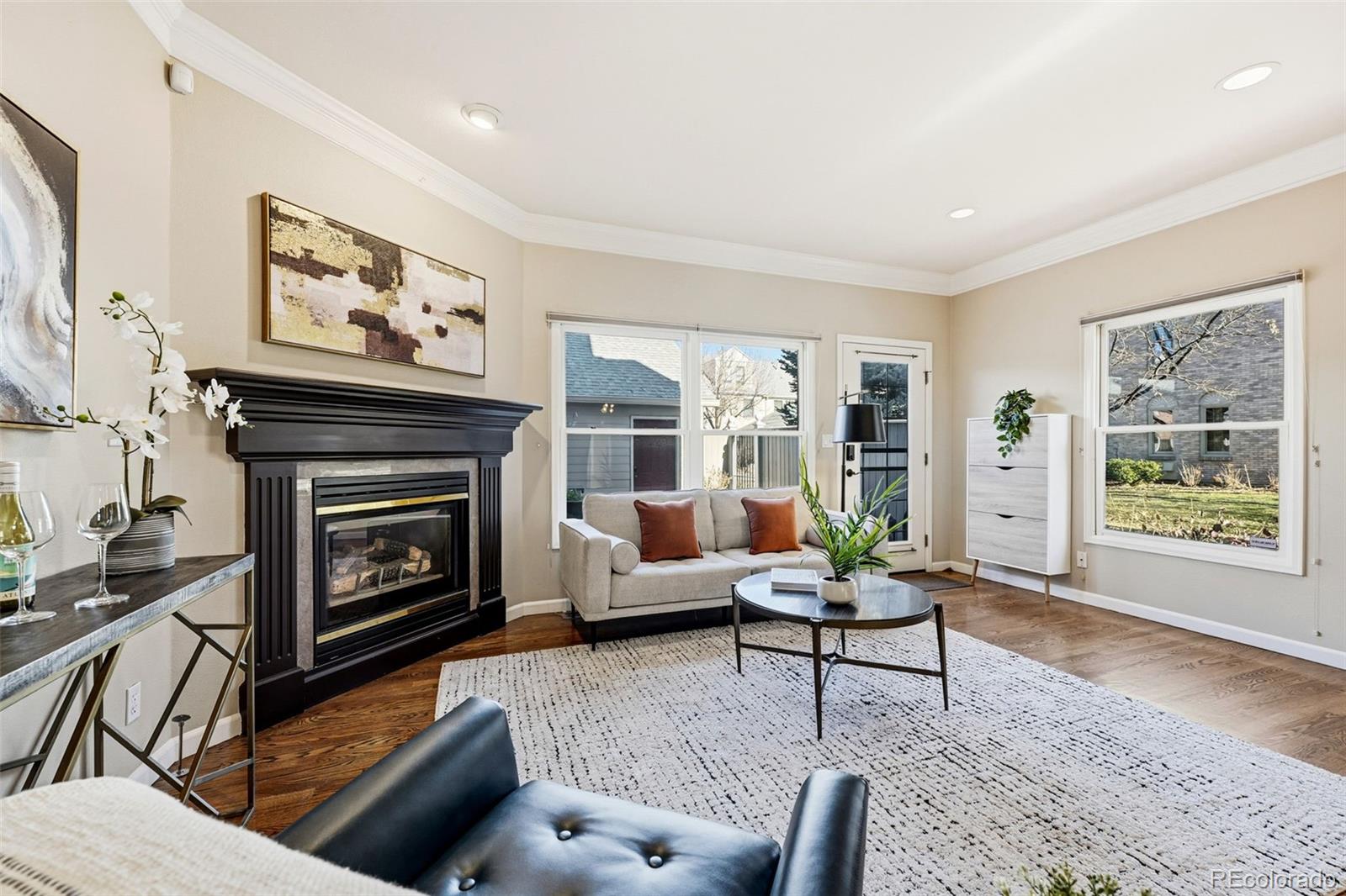944 Ivanhoe Street Denver, CO 80220 - Photo 8 of 50 a living room with furniture a window and a fireplace