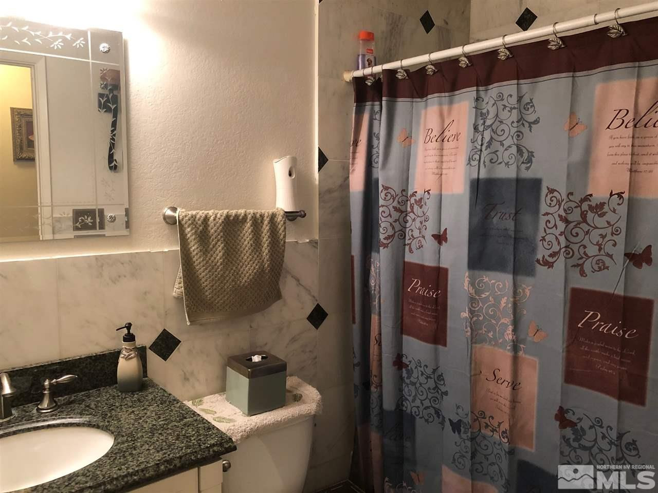 4200 Santa Maria Drive Reno, NV 89502 - Photo 11 of 14 a bathroom with a granite countertop shower sink and mirror