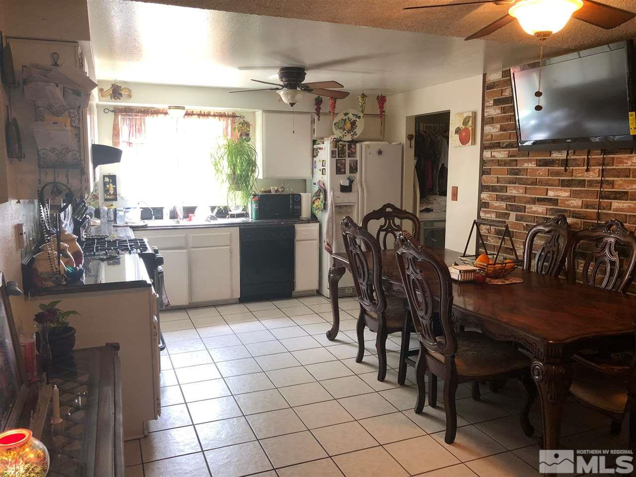 4200 Santa Maria Drive Reno, NV 89502 - Photo 3 of 14 a kitchen with stainless steel appliances a stove refrigerator and chairs