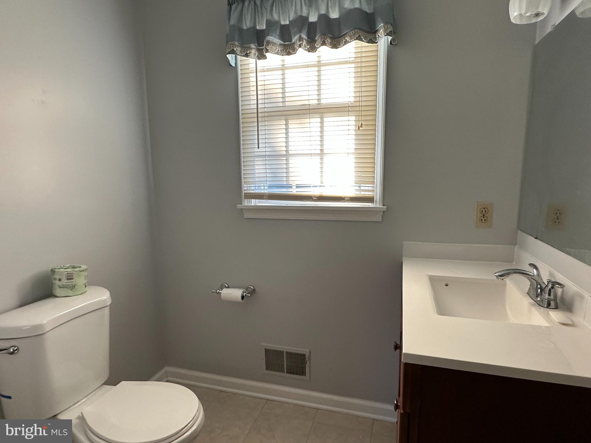 703 Lora Lane Hockessin, DE 19707 - Photo 16 of 28 a white toilet sitting next to a bathroom sink