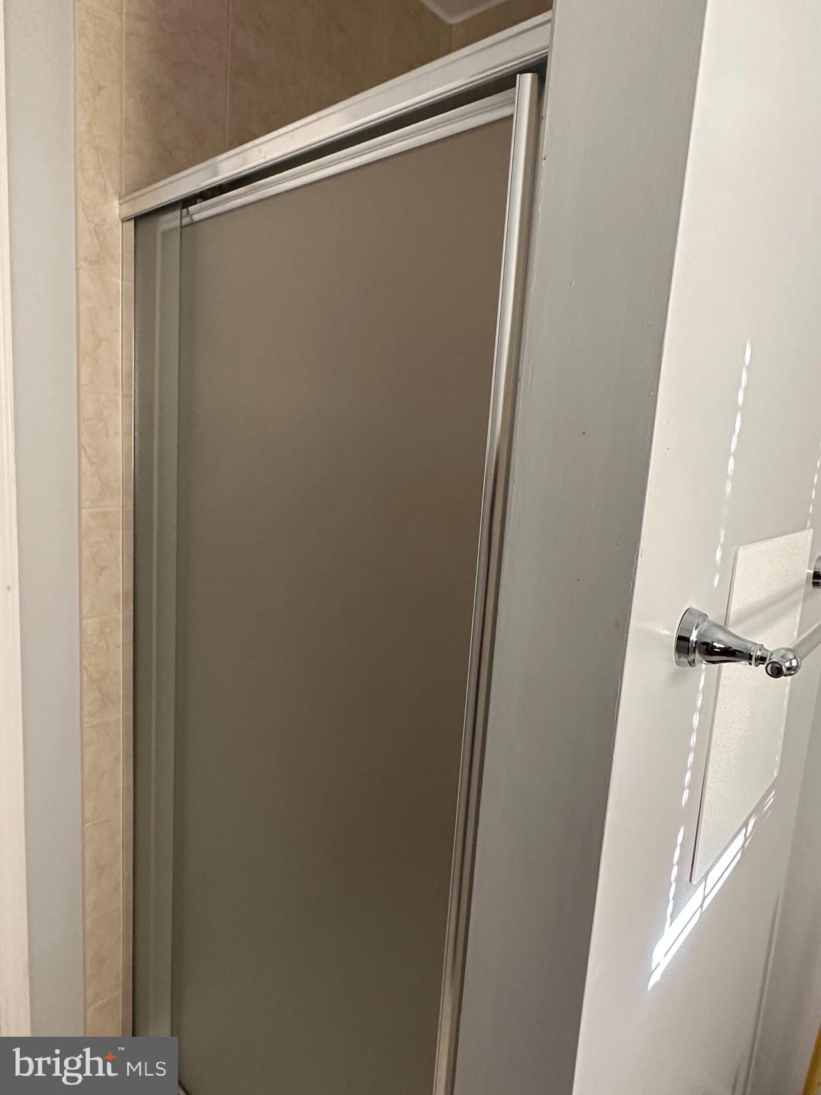 703 Lora Lane Hockessin, DE 19707 - Photo 17 of 28 a bathroom with a glass shower door