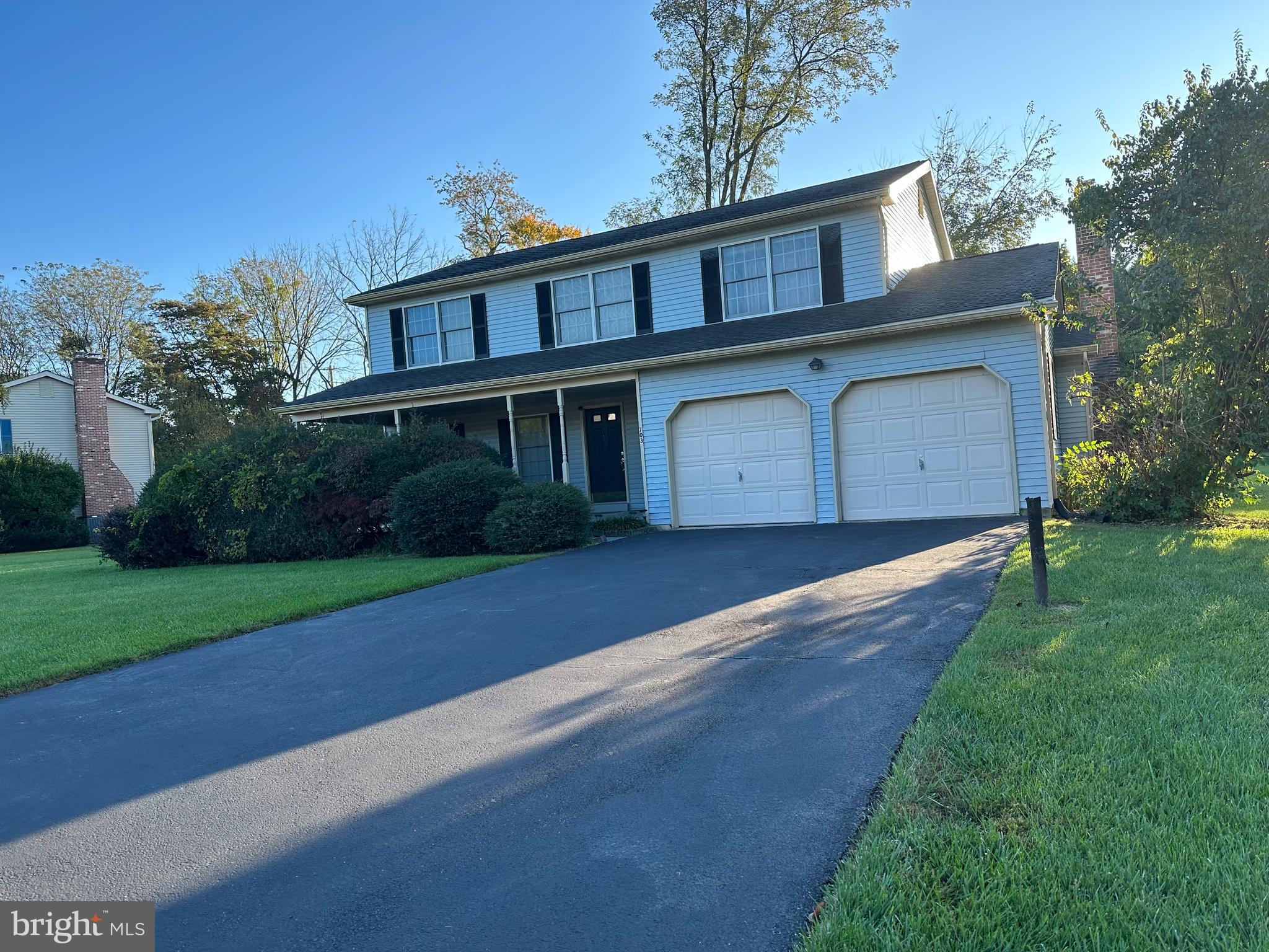 703 Lora Lane Hockessin, DE 19707 - Photo 2 of 28 a front view of a house with a yard and garage