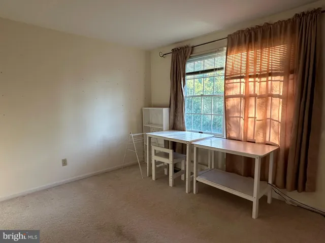 a room with table chair and window