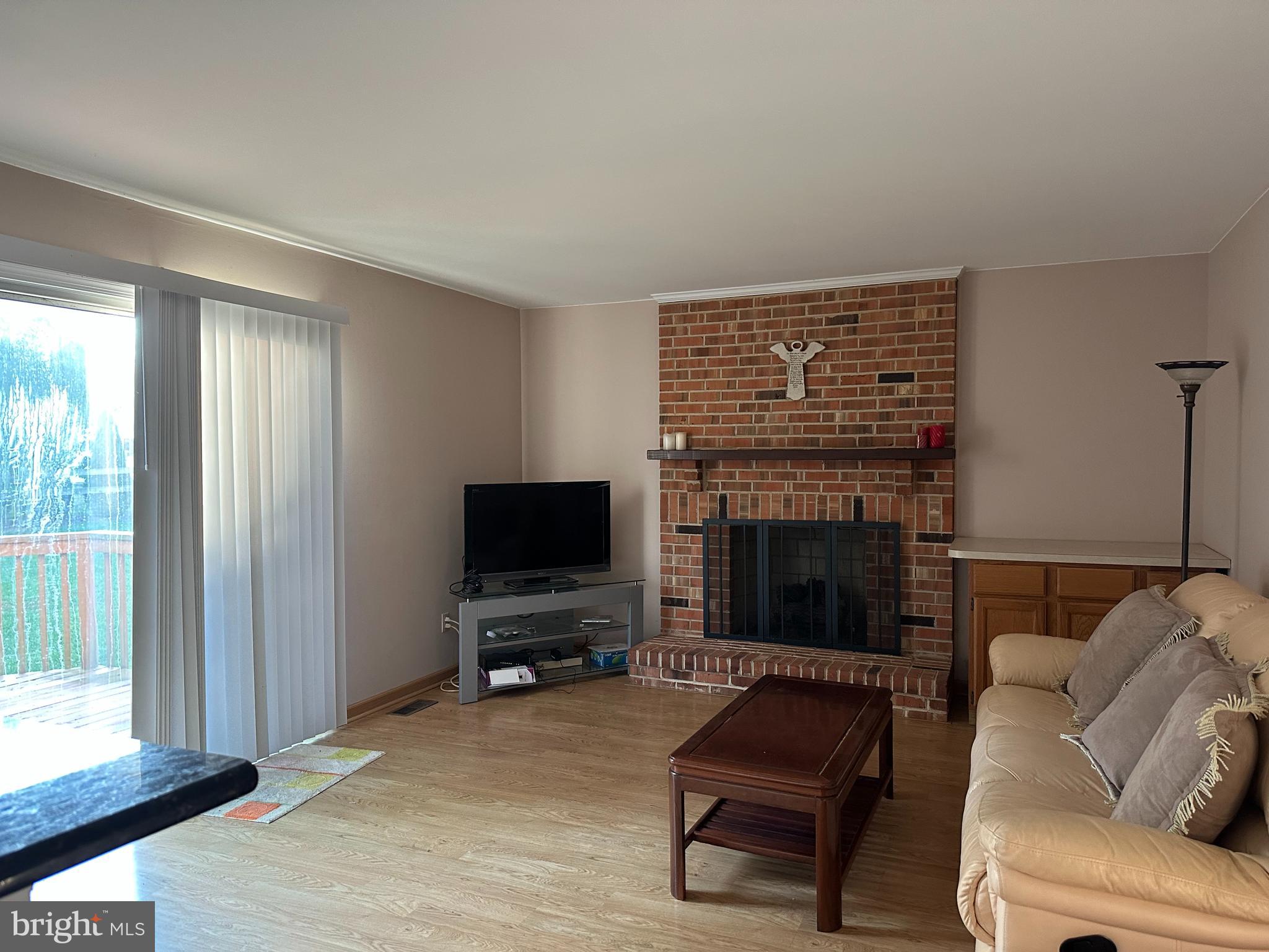 703 Lora Lane Hockessin, DE 19707 - Photo 7 of 28 a living room with furniture and a fireplace