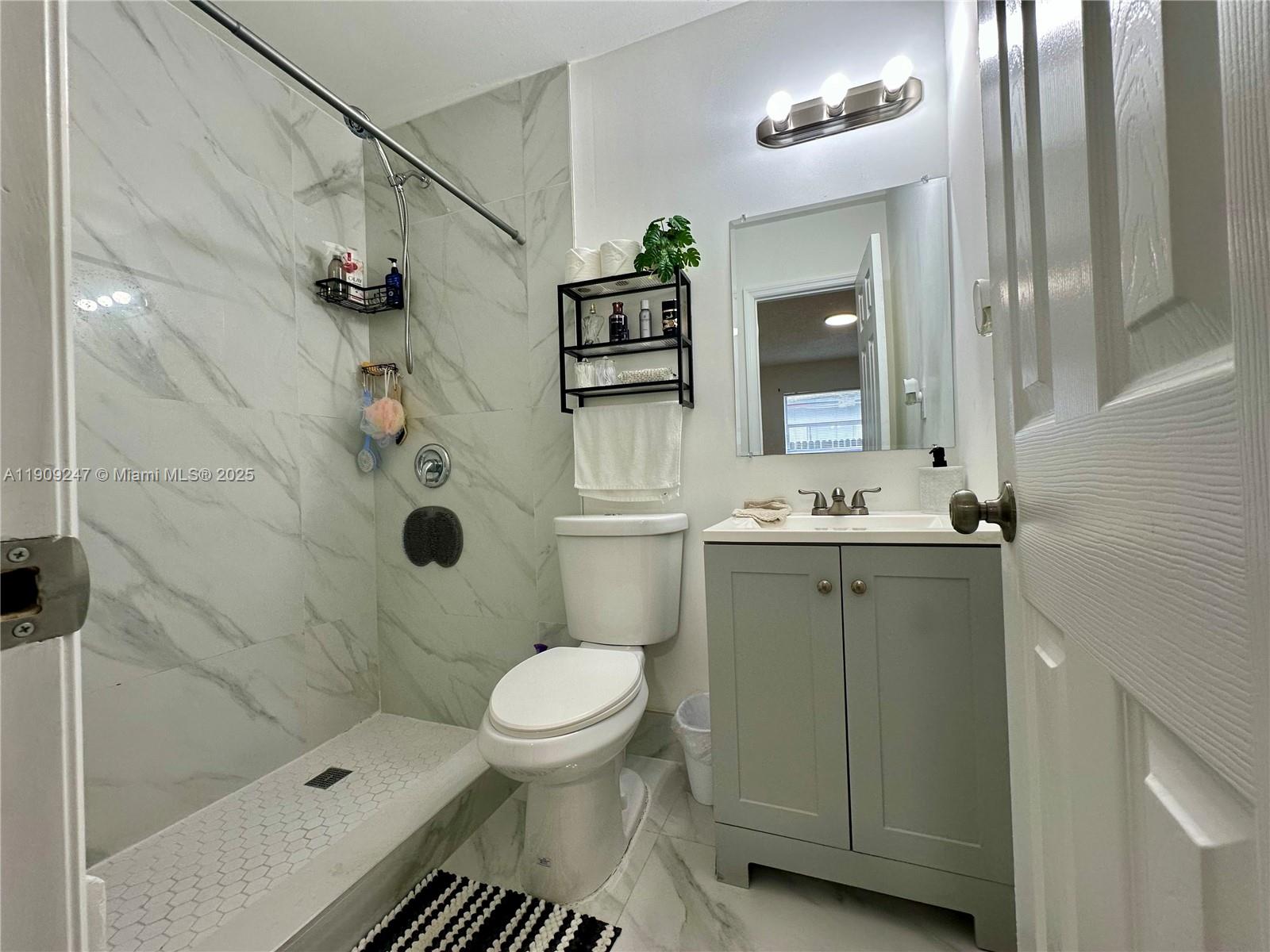 6040 Southwest 35th Street, Unit 2 Miramar, FL 33023 - Photo 11 of 14 a bathroom with a sink toilet and shower