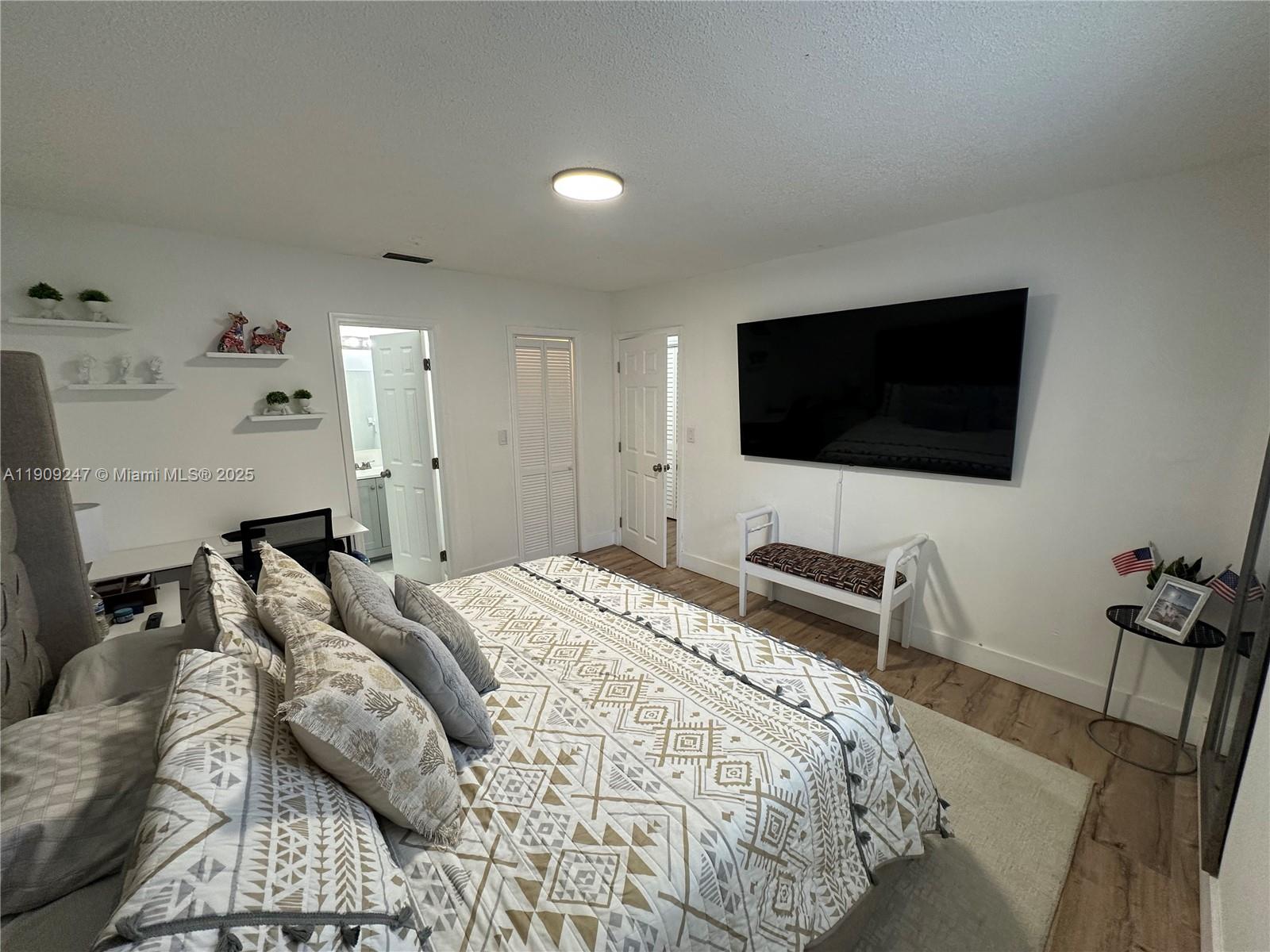 6040 Southwest 35th Street, Unit 2 Miramar, FL 33023 - Photo 12 of 14 a bedroom with a bed and a flat screen tv