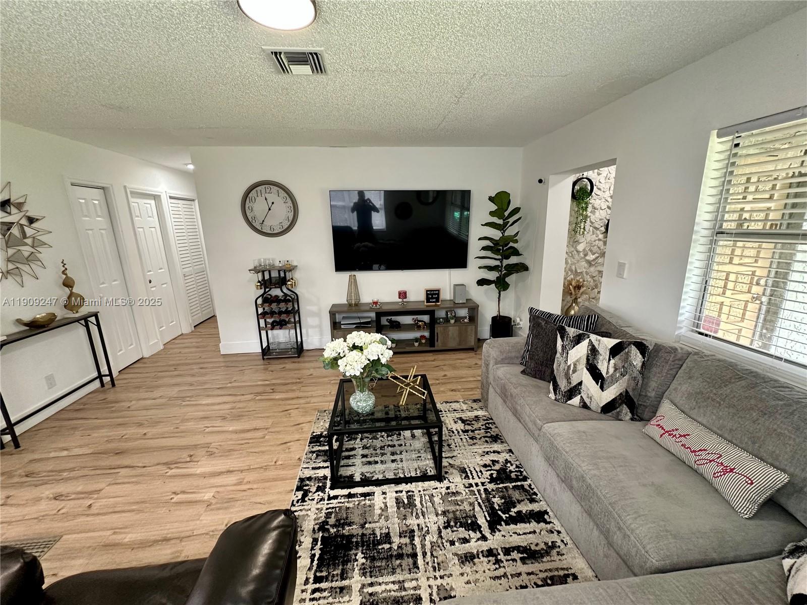 6040 Southwest 35th Street, Unit 2 Miramar, FL 33023 - Photo 3 of 14 a kitchen with a stove and a flat screen tv