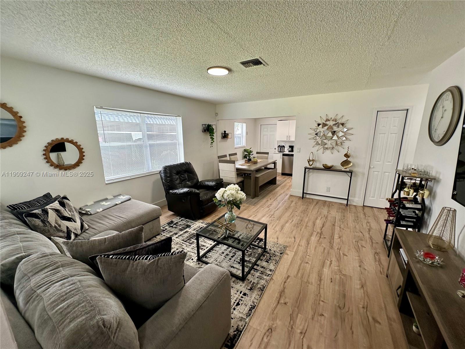 6040 Southwest 35th Street, Unit 2 Miramar, FL 33023 - Photo 4 of 14 a living room with furniture and wooden floor