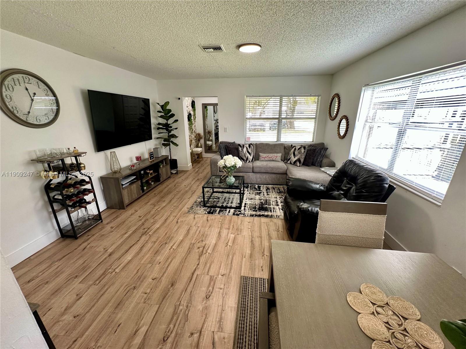 6040 Southwest 35th Street, Unit 2 Miramar, FL 33023 - Photo 7 of 14 a living room with furniture and a flat screen tv
