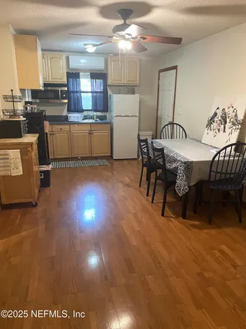 a view of a dining room with furniture and wooden floor