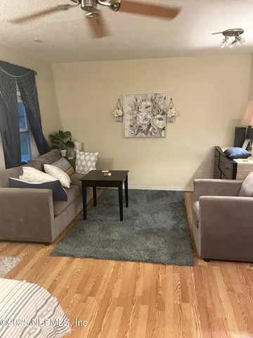 a living room with furniture and wall paintings