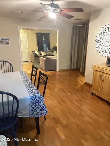a view of a dining room with furniture and a chandelier