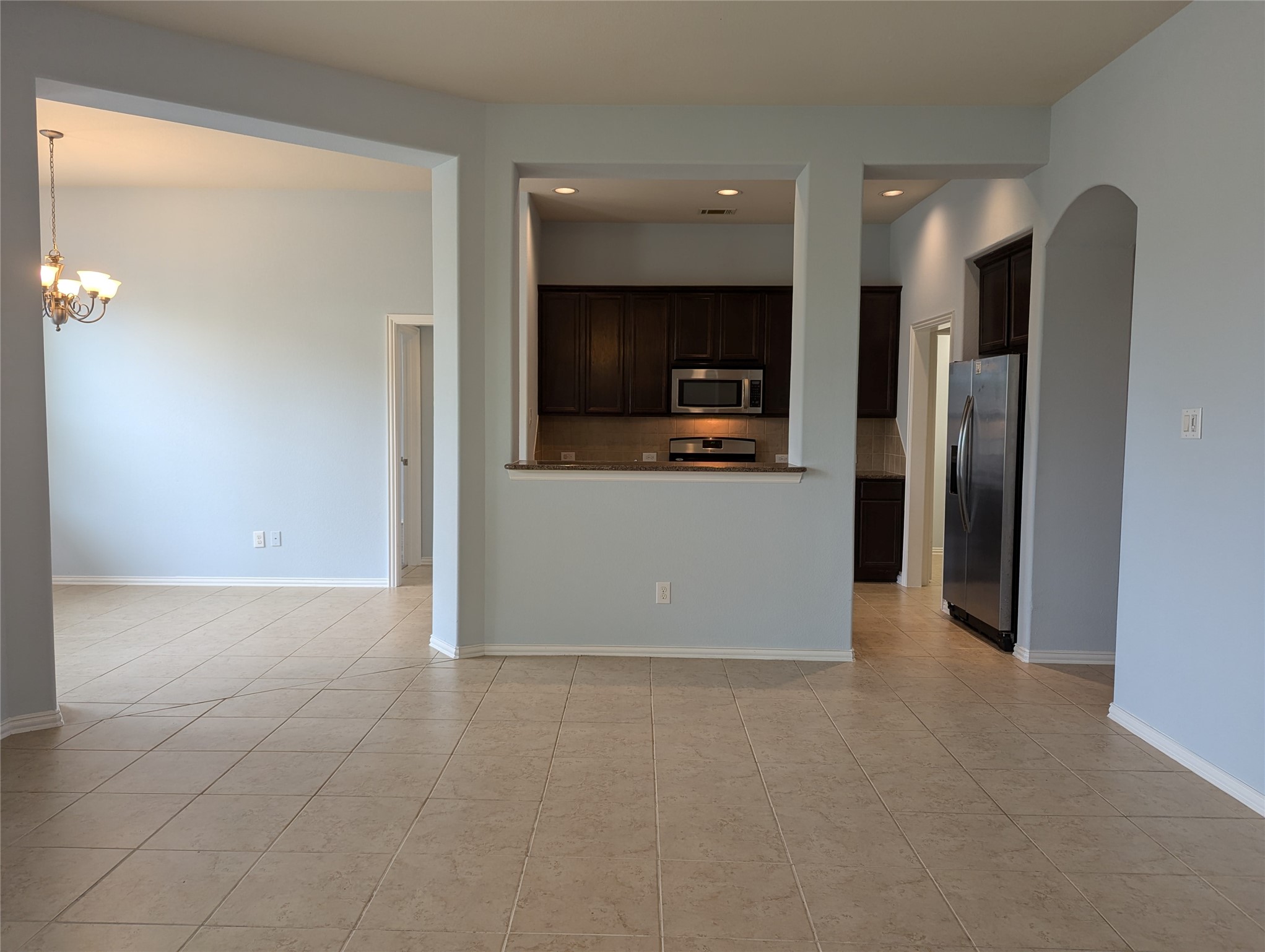 8041 Silent Deep Drive Rosenberg, TX 77469 - Photo 7 of 24 Seamless Flow from Family Room to Modern Kitchen