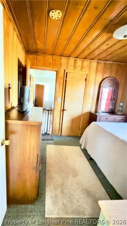 a bedroom with a bed and large windows