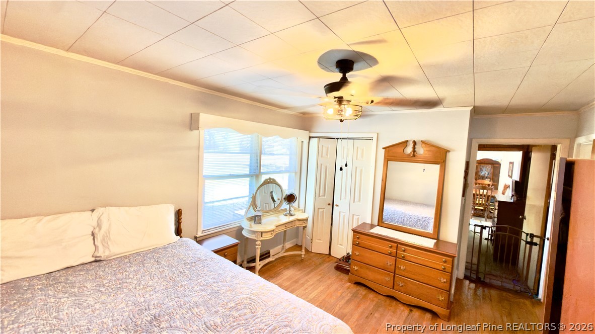 5271 Tobacco Road Orrum, NC 28369 - Photo 20 of 49 a spacious bedroom with a bed and a chandelier