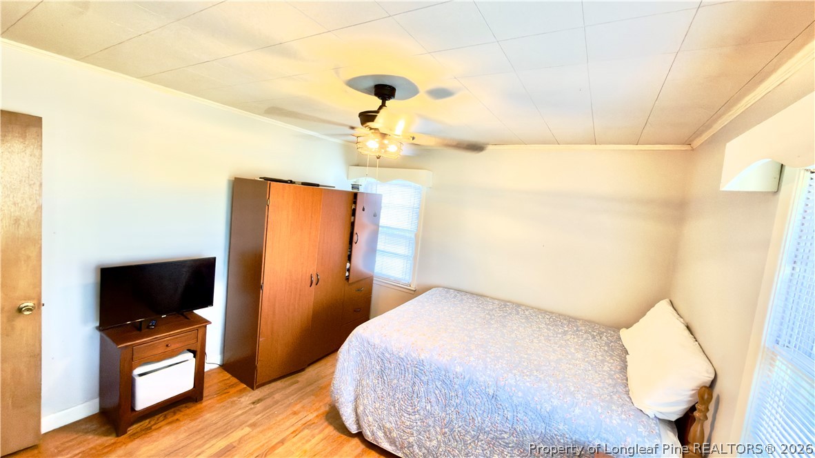 5271 Tobacco Road Orrum, NC 28369 - Photo 21 of 49 a bedroom with a bed and wooden floor