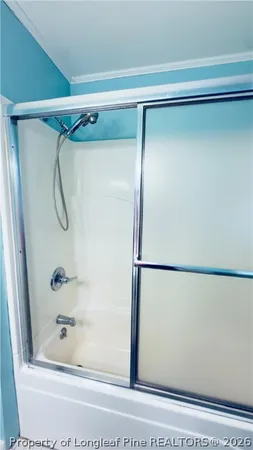 a bathroom with a shower and toilet