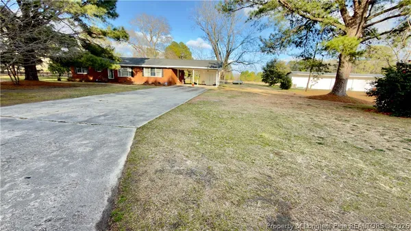 a view of a house with backyard of the house