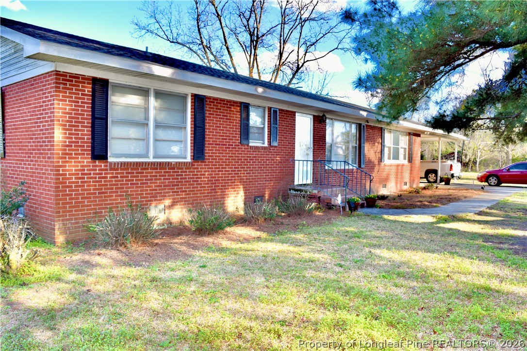5271 Tobacco Road Orrum, NC 28369 - Photo 39 of 49 a view of a house with a yard
