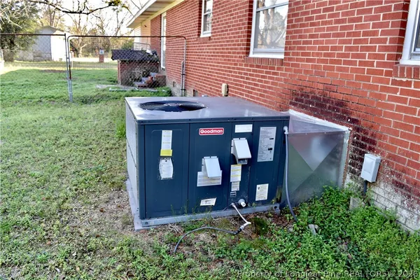 a backyard of a house with yard and trampoline