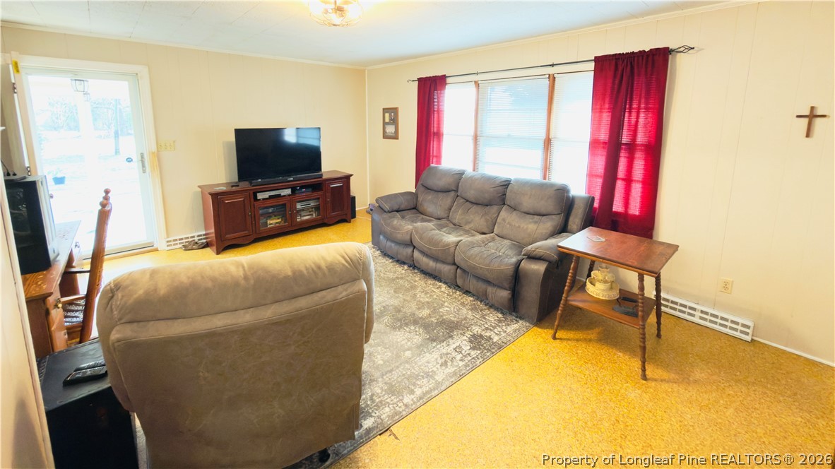 5271 Tobacco Road Orrum, NC 28369 - Photo 9 of 49 a living room with furniture and a flat screen tv