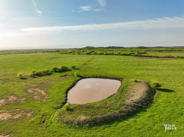 a view of a lake with a yard