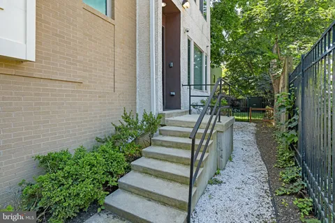 a view of entryway with wooden floor and stairs
