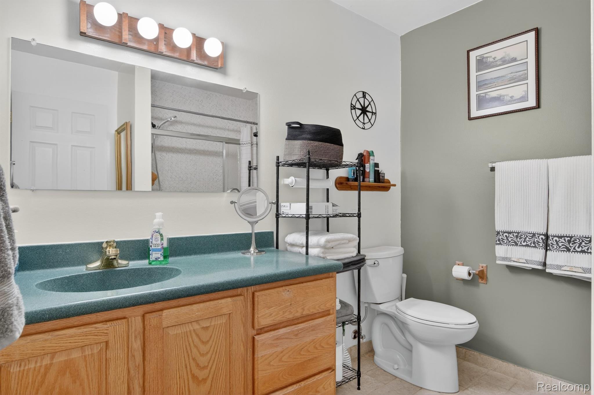 24111 Meridian Road, Unit 116 Grosse Ile, MI 48138 - Photo 19 of 26 Full bathroom featuring a single vanity with a laminate countertop and an integrated sink