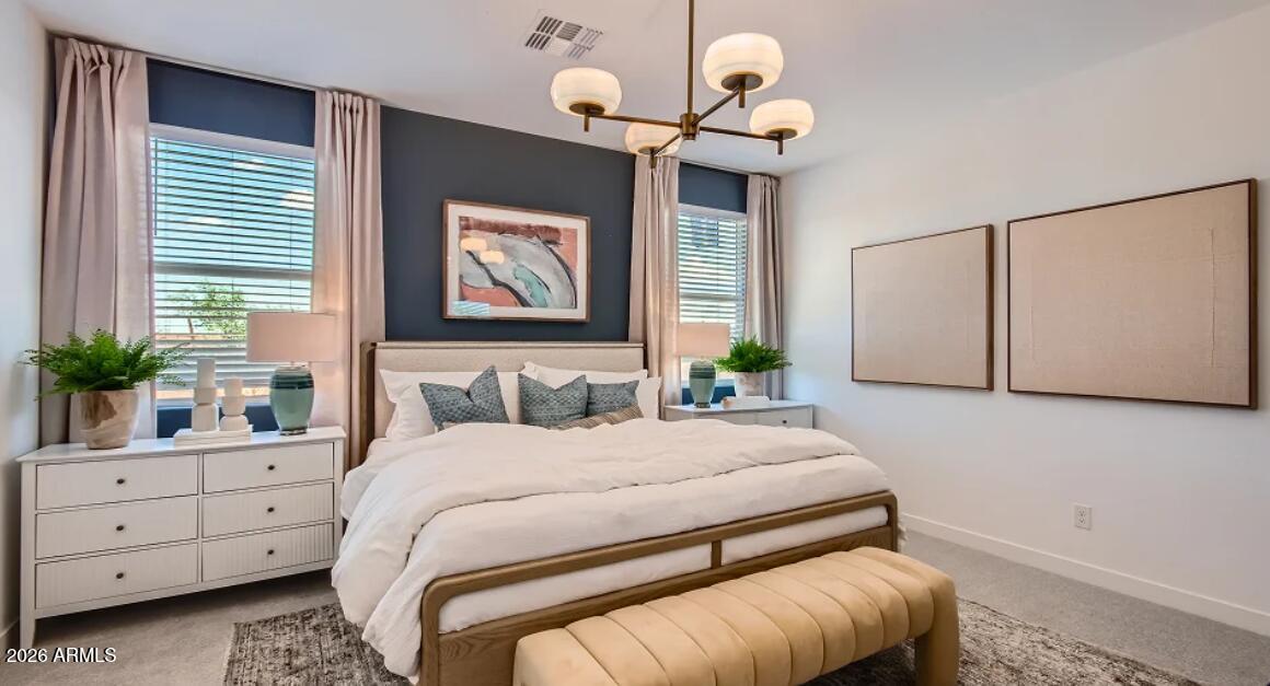 2123 Rutledge Avenue Apache Junction, AZ 85120 - Photo 7 of 21 a bedroom with a bed and a chandelier