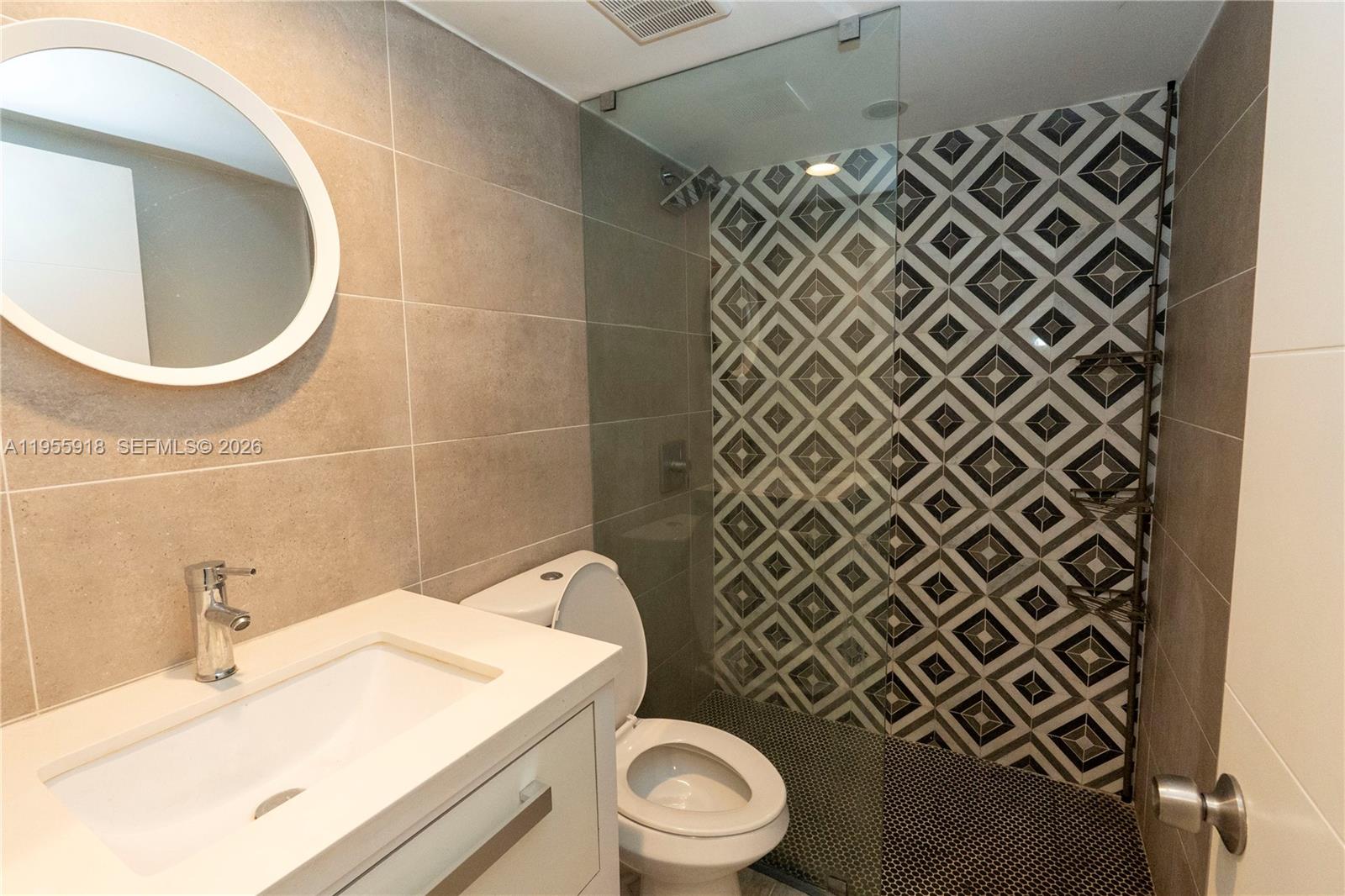 7743 Southwest 86th Street, Unit D227 Miami, FL 33143 - Photo 14 of 24 a bathroom with a sink a toilet and a mirror