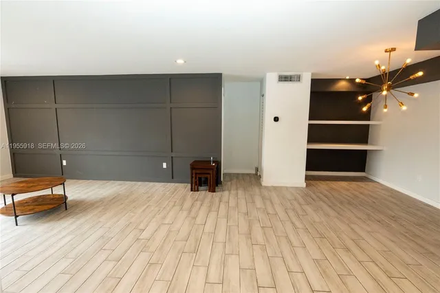 a room with a bed and cabinets