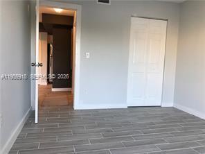 7743 Southwest 86th Street, Unit D227 Miami, FL 33143 - Photo 21 of 24 wooden floor in an empty room